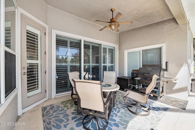 view of patio / terrace featuring ceiling fan, a fire pit, and grilling area