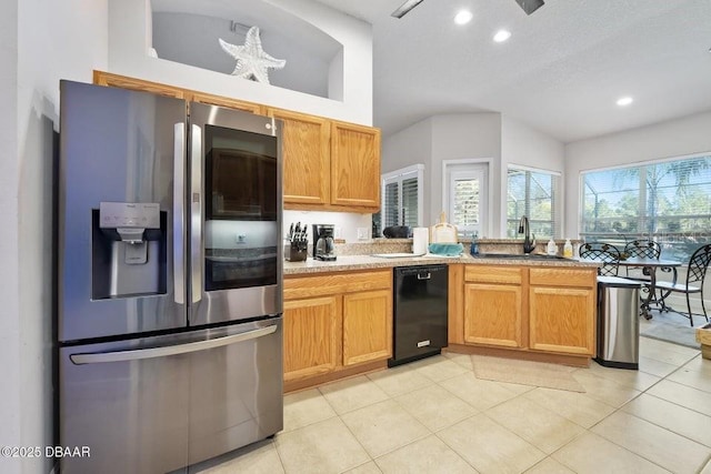 kitchen featuring sink, dishwasher, stainless steel refrigerator with ice dispenser, and light tile patterned floors