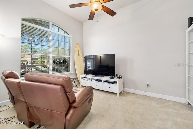 carpeted living room with ceiling fan