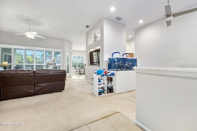 carpeted living room featuring ceiling fan