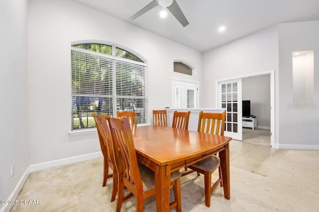 dining area featuring french doors, light carpet, and plenty of natural light