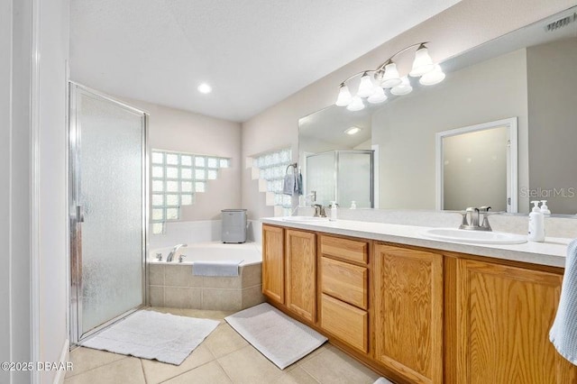 bathroom with tile patterned floors, independent shower and bath, and vanity