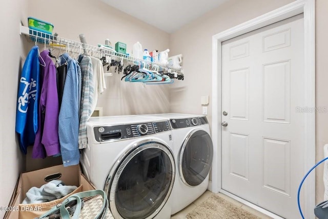 clothes washing area featuring washer and dryer and tile patterned floors