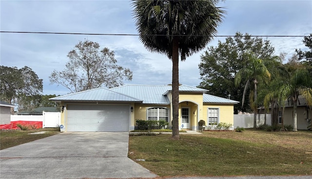 view of front of house featuring a garage and a front lawn