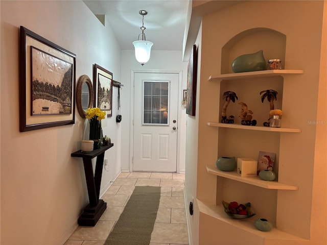 doorway with light tile patterned floors