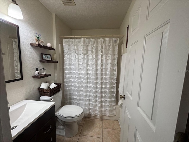 full bathroom featuring toilet, vanity, shower / bath combo with shower curtain, tile patterned floors, and a textured ceiling