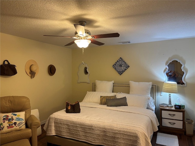 bedroom featuring a textured ceiling and ceiling fan