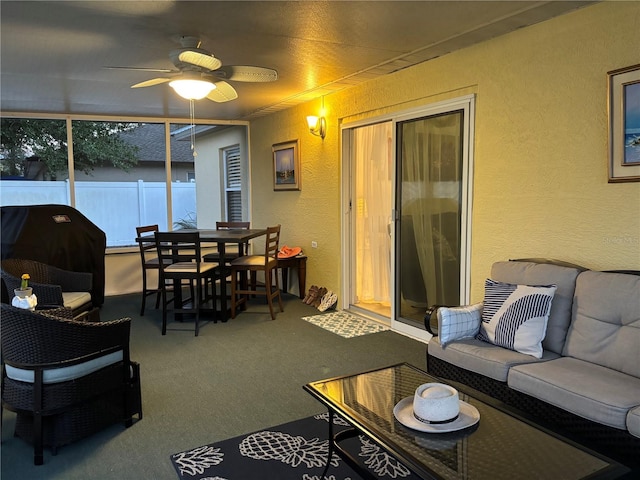 sunroom / solarium featuring ceiling fan