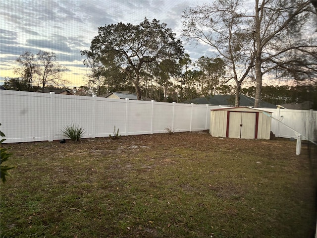 yard at dusk featuring a shed