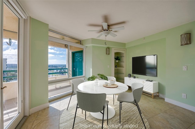 tiled dining area featuring ceiling fan