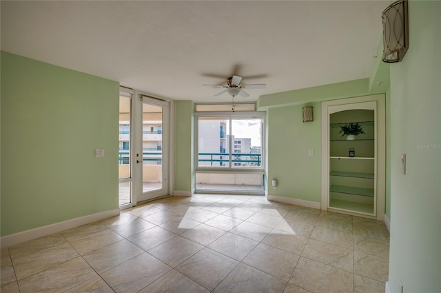 tiled empty room with ceiling fan