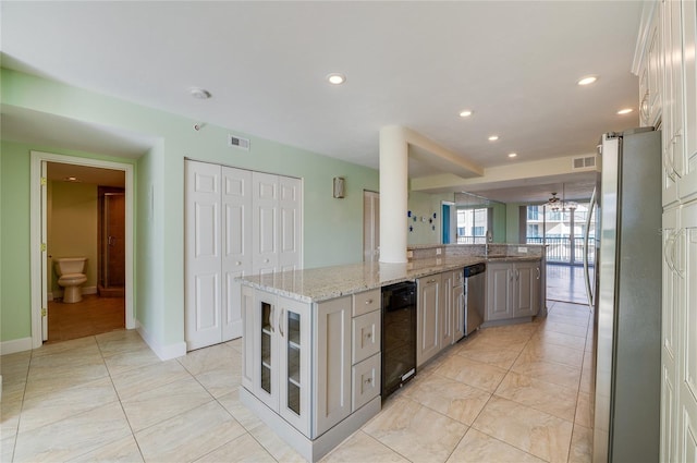 kitchen featuring gray cabinets, stainless steel appliances, white cabinets, and a center island