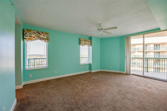 empty room with ceiling fan and carpet floors