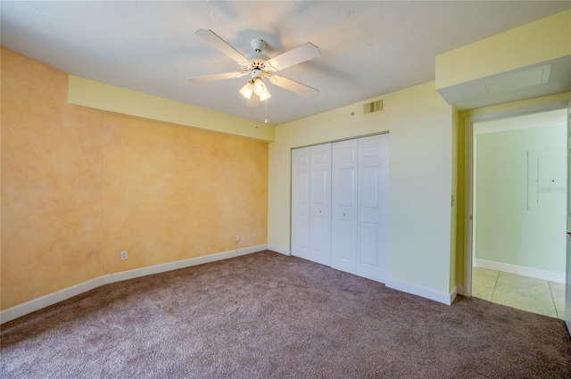 unfurnished bedroom with ceiling fan, a closet, and carpet flooring