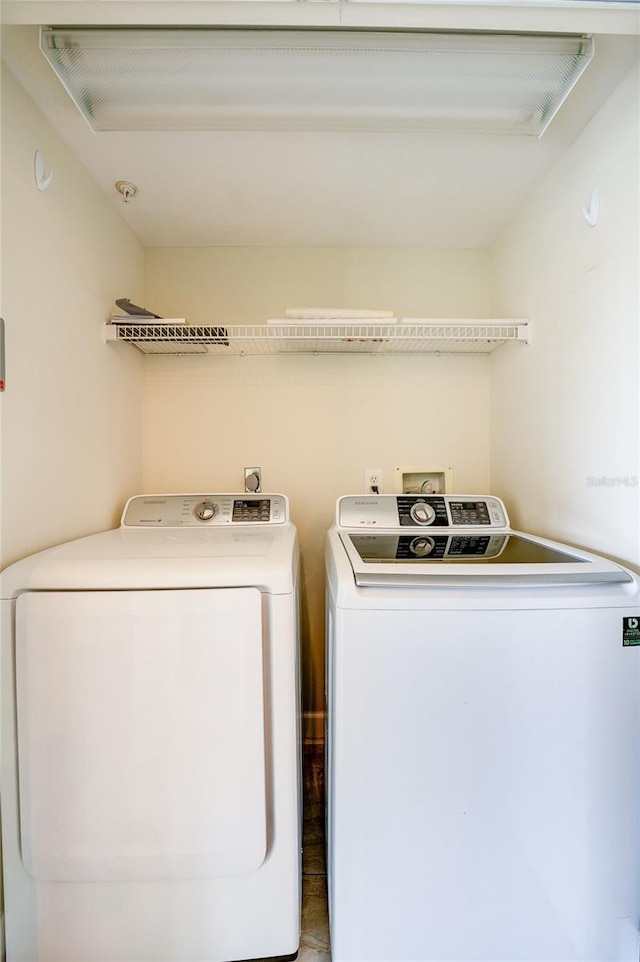 clothes washing area with tile patterned floors and washing machine and clothes dryer