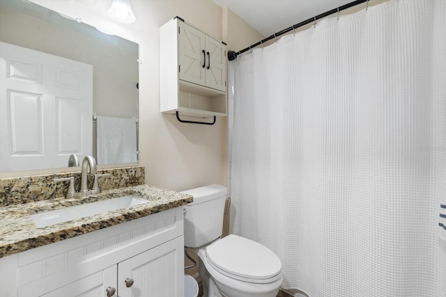 bathroom featuring toilet and vanity