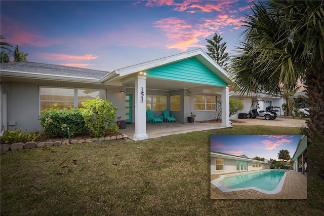 151 N Palmetto Ave, Flagler Beach, FL 32136 - back house at dusk featuring a patio area and a yard