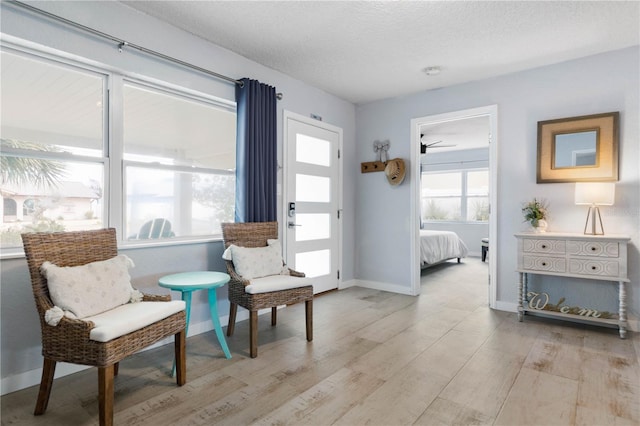 sitting room with a textured ceiling and light hardwood / wood-style floors