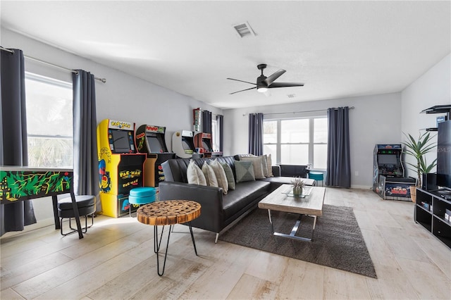 living room with light wood-type flooring and ceiling fan