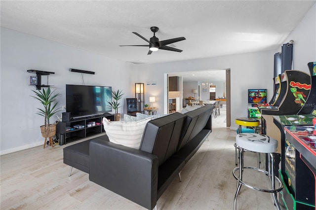 living room featuring ceiling fan and light hardwood / wood-style floors