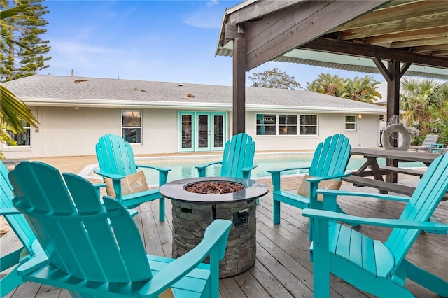 wooden deck featuring an outdoor fire pit