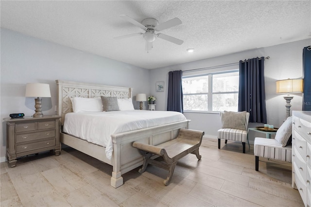 bedroom with a textured ceiling and ceiling fan