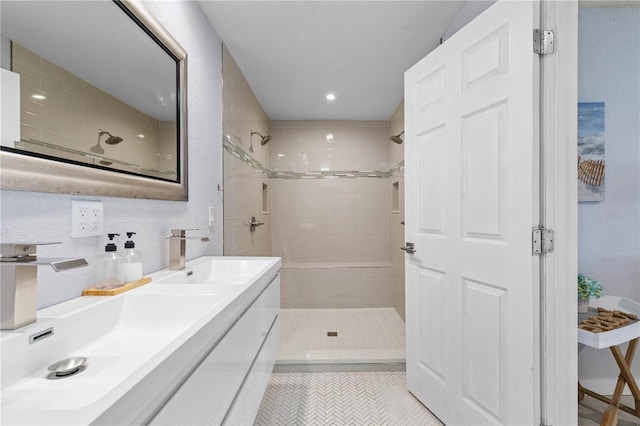 bathroom with vanity, tile patterned flooring, and tiled shower