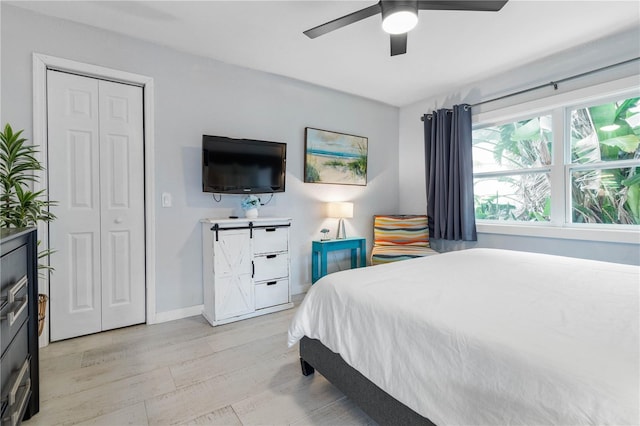 bedroom with ceiling fan and a closet