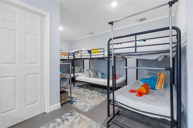 bedroom with crown molding and a textured ceiling