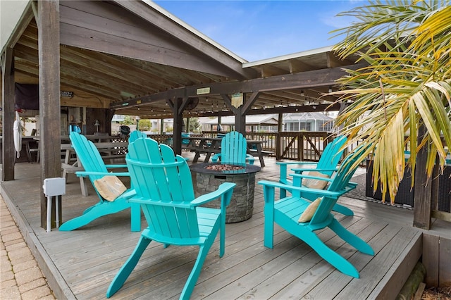 wooden deck featuring a fire pit