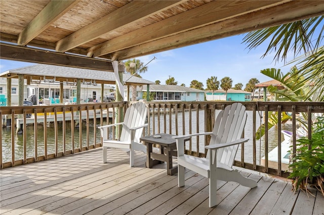 wooden terrace featuring a water view