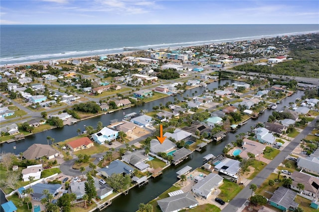 bird's eye view featuring a water view and a beach view