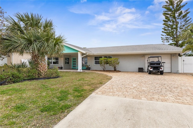 single story home featuring a front yard and a garage