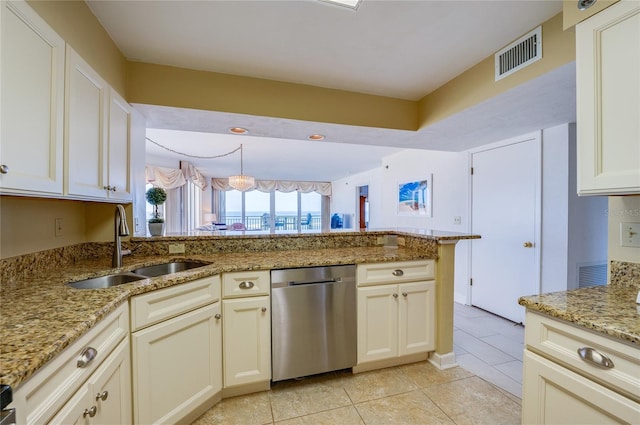 kitchen with light tile patterned floors, sink, stainless steel dishwasher, and light stone countertops