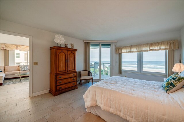 bedroom featuring a water view and access to outside