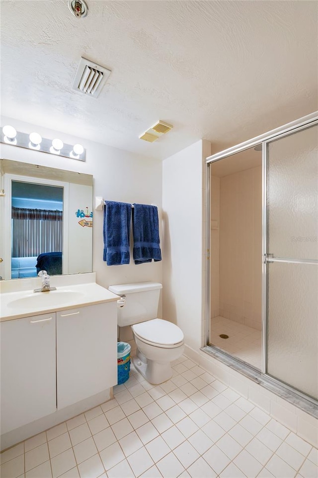 bathroom with toilet, a shower with door, tile patterned floors, a textured ceiling, and vanity