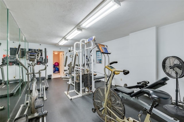 gym with a textured ceiling