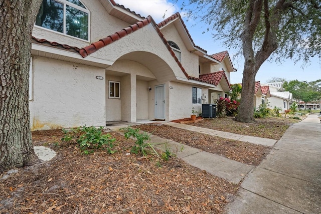 mediterranean / spanish-style home featuring central air condition unit