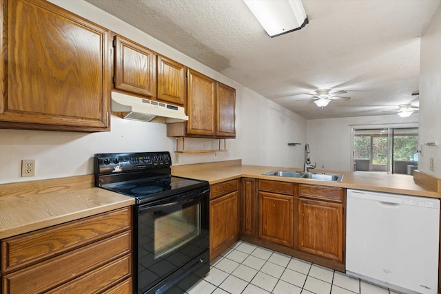 kitchen with kitchen peninsula, black range with electric stovetop, sink, white dishwasher, and a textured ceiling