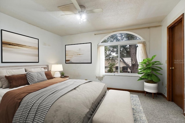 bedroom with carpet floors, a textured ceiling, and ceiling fan