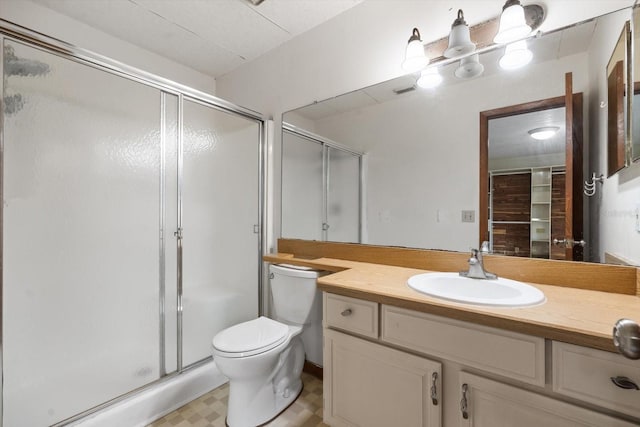 bathroom with an enclosed shower, vanity, and toilet