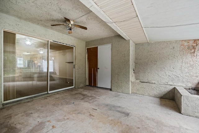 spare room featuring ceiling fan and concrete flooring