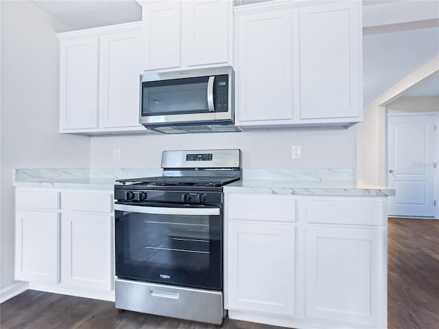 kitchen with white cabinetry, dark wood-type flooring, and appliances with stainless steel finishes