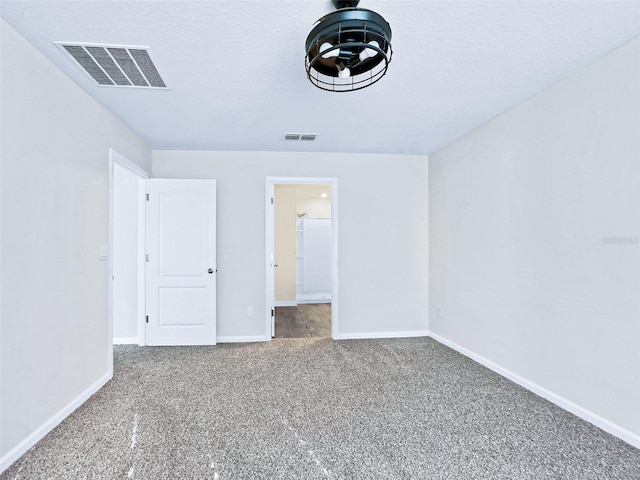 unfurnished bedroom featuring a textured ceiling and carpet flooring