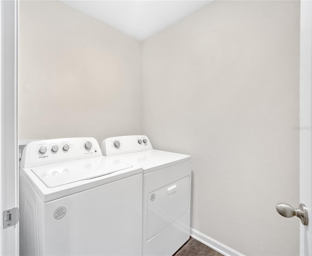 clothes washing area featuring separate washer and dryer