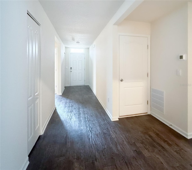 hallway featuring dark hardwood / wood-style flooring