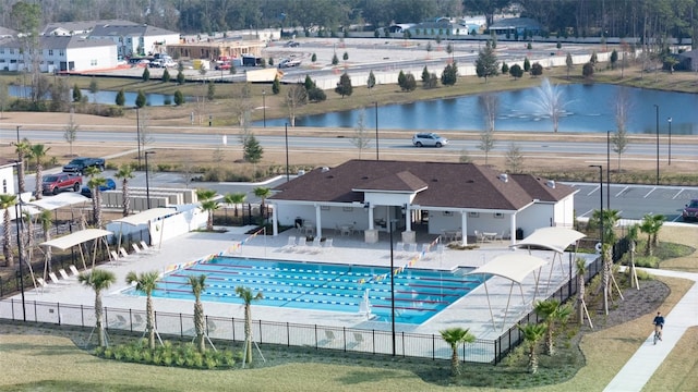 view of swimming pool with a patio and a water view