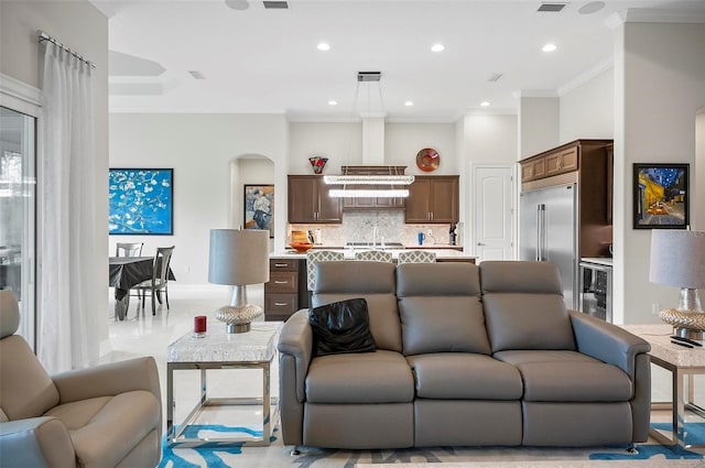 living room featuring crown molding and beverage cooler