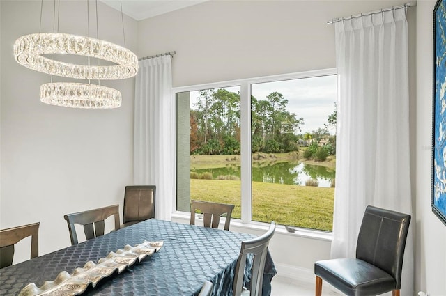 dining space featuring a water view and a chandelier