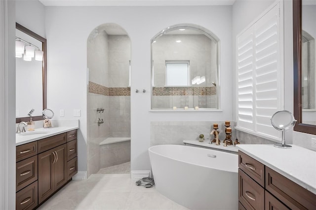 bathroom with vanity, tile patterned flooring, and shower with separate bathtub